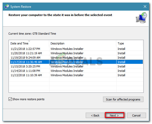 Select a system restore point and click Next