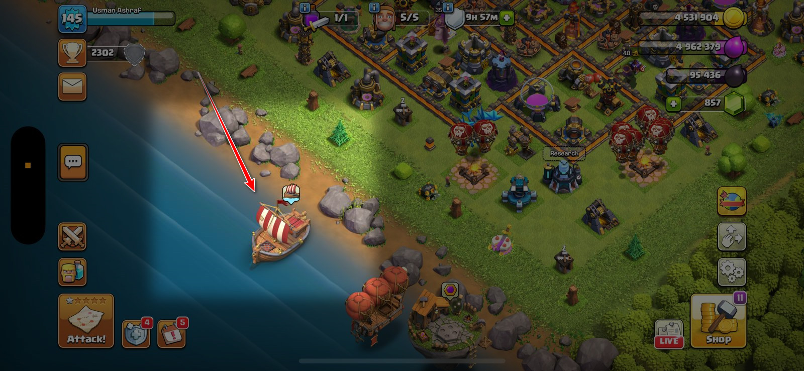 Clash of Clans boat on the shoreline used to travel to the Builder Base, highlighted with a red arrow.